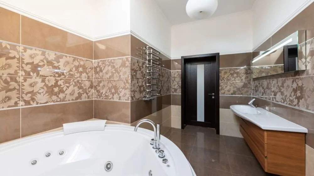 Compact modern bathroom with a floating vanity large mirror and matt floor tiles
