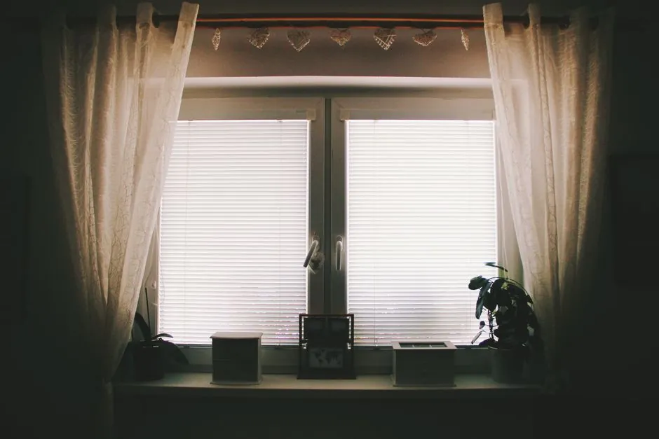 Eyelet curtain design with sheer panels framing a bright window
