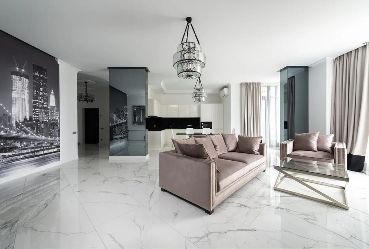 Large format polished marble look floor tiles in an open living room