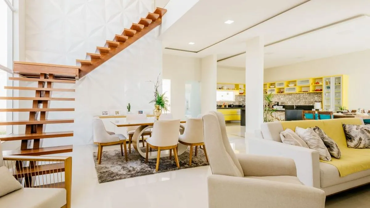 Open timber floating staircase beside a bright living and dining area in a modern home