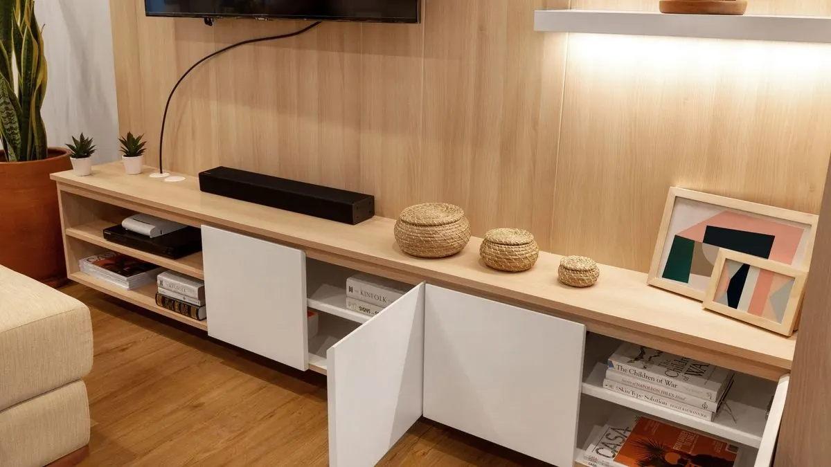Low TV unit with open shelves and closed storage doors for devices