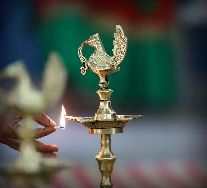 Brass oil lamp and idols arranged in a small Indian pooja room