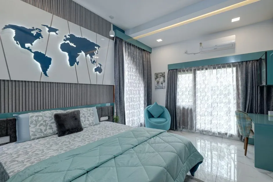 Bedroom with a muted teal headboard wall and teal trim against white walls